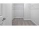 Spacious walk-in closet with metal shelving and neutral carpeting is ready for organizing your wardrobe at 425 Providence Springs Ln, Fuquay Varina, NC 27526