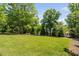Large, grassy backyard with mature trees and a hammock at 4404 Yadkin Dr, Raleigh, NC 27609
