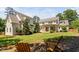Beautifully landscaped backyard featuring two Adirondack chairs under a shady tree at 4404 Yadkin Dr, Raleigh, NC 27609