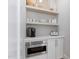 A small, bright bar area with built-in shelves and a microwave at 4404 Yadkin Dr, Raleigh, NC 27609