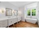 Bright bathroom showcasing a double vanity, modern tub, and window view at 4404 Yadkin Dr, Raleigh, NC 27609