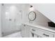 Modern bathroom featuring white cabinets with black pulls, quartz countertops, and a seamless glass shower at 4404 Yadkin Dr, Raleigh, NC 27609