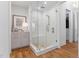 Bathroom shower with glass door, and herringbone tile at 4404 Yadkin Dr, Raleigh, NC 27609