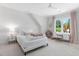 Bedroom featuring a plush bed, window views, and charming decor at 4404 Yadkin Dr, Raleigh, NC 27609