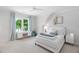 Bright bedroom featuring a large window with blue curtains and a desk area with a chair at 4404 Yadkin Dr, Raleigh, NC 27609