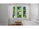 Bedroom featuring a large window showcasing a view of lush greenery at 4404 Yadkin Dr, Raleigh, NC 27609