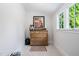 Bedroom storage with a rustic wooden dresser illuminated by natural light from a nearby window at 4404 Yadkin Dr, Raleigh, NC 27609