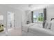 Bedroom showcasing a bright window, white walls and trim, and neutral carpeting at 4404 Yadkin Dr, Raleigh, NC 27609