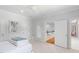 Neutral toned bedroom featuring a ceiling fan, carpet flooring, and views to the staircase and another room at 4404 Yadkin Dr, Raleigh, NC 27609