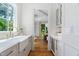 Butler's pantry featuring white cabinetry, an apron sink, and hardwood floors at 4404 Yadkin Dr, Raleigh, NC 27609