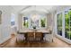 Bright dining room featuring hardwood floors, statement lighting, and views of the home's yard at 4404 Yadkin Dr, Raleigh, NC 27609