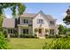 Stunning two-story painted brick home with mature trees, manicured lawn and beautifully trimmed shrubbery at 4404 Yadkin Dr, Raleigh, NC 27609