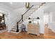 Home's light-filled foyer featuring hardwood floors, staircase and views to other living spaces at 4404 Yadkin Dr, Raleigh, NC 27609