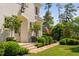 Home's entry with professionally landscaped yard, trees, stone pathway and American flag in background at 4404 Yadkin Dr, Raleigh, NC 27609