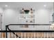 Hallway area with black railing and white posts, including a decorative shelf with floral arrangement at 4404 Yadkin Dr, Raleigh, NC 27609