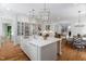 Bright open kitchen with large island, stainless appliances, and hardwood floors at 4404 Yadkin Dr, Raleigh, NC 27609