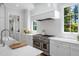 Bright kitchen features stainless appliances, white cabinetry, and an apron sink at 4404 Yadkin Dr, Raleigh, NC 27609