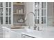 Close-up of an apron sink with a chrome faucet and white countertops at 4404 Yadkin Dr, Raleigh, NC 27609