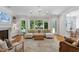 Living room featuring a white sectional sofa, hardwood floors, and an abundance of natural light at 4404 Yadkin Dr, Raleigh, NC 27609