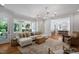 Spacious living room with hardwood floors, white sofa, and large windows offering plenty of natural light at 4404 Yadkin Dr, Raleigh, NC 27609