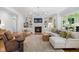 Inviting living room featuring a fireplace, white built-ins, comfortable seating, and ample natural light at 4404 Yadkin Dr, Raleigh, NC 27609