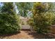 Backyard shed surrounded by lush greenery and mature trees at 4404 Yadkin Dr, Raleigh, NC 27609