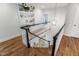 Bright staircase with hardwood floors, black and white railings, and custom built-in shelves at 4404 Yadkin Dr, Raleigh, NC 27609
