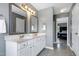 Bright bathroom featuring a double sink vanity and a glimpse of the bedroom at 4725 Parr Vista Ct, Raleigh, NC 27612