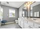 Bright bathroom with a double sink vanity and a view to the window at 4725 Parr Vista Ct, Raleigh, NC 27612