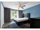 Bedroom with blue walls featuring a window and dark wood furniture at 4725 Parr Vista Ct, Raleigh, NC 27612