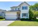 Charming two-story home features a well-manicured front yard and attached two car garage at 4725 Parr Vista Ct, Raleigh, NC 27612