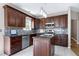 Updated kitchen featuring custom cabinets, a kitchen island, and stainless steel appliances at 4725 Parr Vista Ct, Raleigh, NC 27612