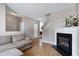 Open-concept living space with a fireplace, plush seating, and a staircase view at 4725 Parr Vista Ct, Raleigh, NC 27612