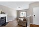 Bright living room with a large sectional sofa, fireplace, and an adjacent entrance door at 4725 Parr Vista Ct, Raleigh, NC 27612