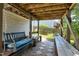 Inviting covered patio features a comfortable swing bench and wooden benches, perfect for relaxing outdoors at 4725 Parr Vista Ct, Raleigh, NC 27612