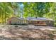 Secluded backyard view of a brick home with a wooden deck and fire pit area at 4901 Old Elizabeth Rd, Raleigh, NC 27616