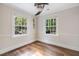 This bedroom boasts hardwood floors and two large windows for abundant natural light and beautiful views at 4901 Old Elizabeth Rd, Raleigh, NC 27616