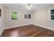 Empty bedroom features hardwood floors, neutral paint, and two windows providing natural light at 4901 Old Elizabeth Rd, Raleigh, NC 27616