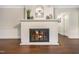 Living room showcasing a white brick fireplace with hearth, perfect for cozy evenings at 4901 Old Elizabeth Rd, Raleigh, NC 27616