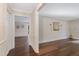 Hallway and living room with hardwood flooring and decorative artwork at 4901 Old Elizabeth Rd, Raleigh, NC 27616