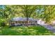 Aerial view of a beautiful single-story brick home with a well-manicured lawn and mature trees at 4901 Old Elizabeth Rd, Raleigh, NC 27616