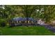 Beautiful single-story brick home with a well-manicured lawn and mature trees at 4901 Old Elizabeth Rd, Raleigh, NC 27616