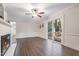 Open living area with ceiling fan, door to deck, and hardwood floors offers a bright and airy space at 4901 Old Elizabeth Rd, Raleigh, NC 27616