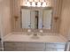 Bathroom vanity area with a large mirror and vintage wallpaper at 4908 Mandel Rd, Durham, NC 27712
