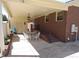 Covered patio area for outdoor dining, constructed with brick and siding, conveniently located near the home's entrance at 4908 Mandel Rd, Durham, NC 27712