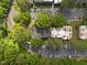 Aerial view of apartment complex surrounded by lush greenery and ample parking at 500 Umstead Dr # 103C, Chapel Hill, NC 27516