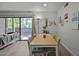 Bright dining area featuring a table and sliding glass doors, leading to outdoor views at 500 Umstead Dr # 103C, Chapel Hill, NC 27516