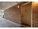 Apartment entrance featuring a brick wall and a secure door with a unit number at 500 Umstead Dr # 103C, Chapel Hill, NC 27516