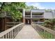 Apartment building connected by a bridge, showcasing balconies and lush greenery at 500 Umstead Dr # 103C, Chapel Hill, NC 27516