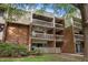 Three-story brick exterior with balconies and landscaping, showcasing architectural style and potential charm at 500 Umstead Dr # 103C, Chapel Hill, NC 27516